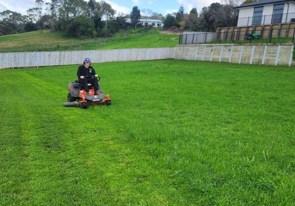 lawns being mowed with a ride on lawn mover in new zealand